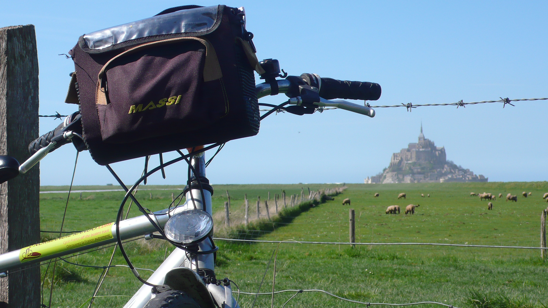 Bike and field of sheep below Mont Saint Michel