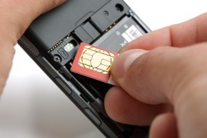 A SIM card being inserted into a phone