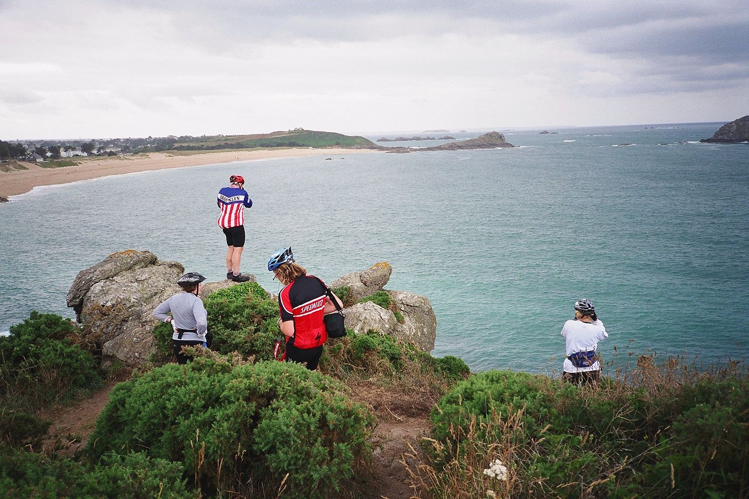Cyclomundo riders looking upon one of Normandy's historic beaches