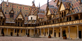 Admire the classical Burgundian style rooftops like the Beaune hospice