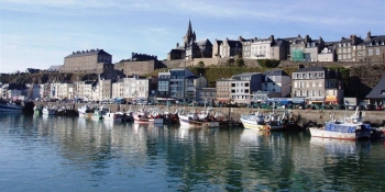 Cycle through the city of Granville located on a cliff, creating a scenic union between land and sea