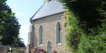 Cycling  on quiet roads though a village with a little chapel